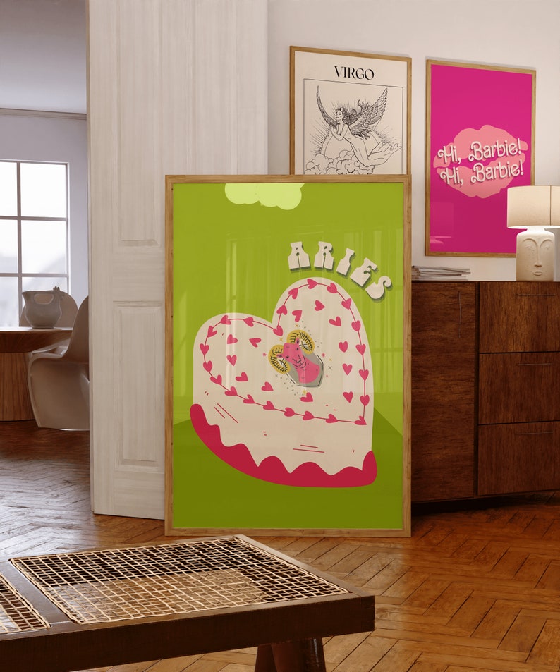 May include: A green poster with a pink heart-shaped cake with a ram inside. The cake is decorated with pink hearts. The word "Aries" is written in a retro font at the top of the poster.