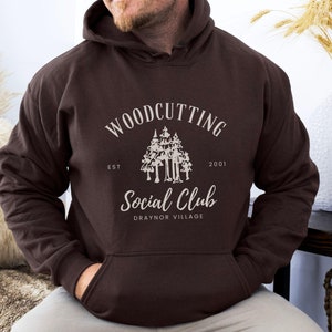 May include: A brown hooded sweatshirt with a white graphic design that says "Woodcutting Social Club Est 2001 Draynor Village".