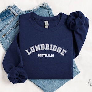 May include: Navy blue sweatshirt with white text that reads "Lumbridge Misthalin".