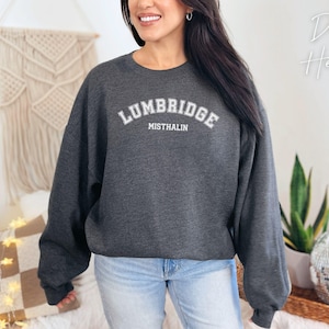 May include: A dark heather grey sweatshirt with the text "LUMBRIDGE MISTHALIN" in white.