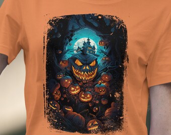 May include: Orange t-shirt featuring a Halloween-themed graphic. The design includes a large, menacing jack-o'-lantern surrounded by smaller pumpkins, a haunted house, and a full moon. The artwork is set against a dark, spooky forest backdrop.