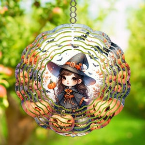 May include: A decorative Halloween ornament featuring a cartoon witch with a black hat and cape, surrounded by pumpkins and bats. The ornament has a layered design with green and orange accents, perfect for seasonal decor.