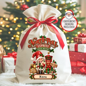 May include: A cream-colored fabric gift sack with a red ribbon drawstring closure. The front features a graphic of a gnome, a red mailbox, and the text North Pole Express Special Delivery and Kora. A circular badge states 5 Different Designs Included.