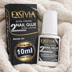 May include: Black and gold box and white bottle of EXSIVIA Extra Strong Nail Glue. The box and bottle have the text "2 Nail Glue Ultra Lasting Second Generation". The bottle contains 10ml (0.3 FL OZ) of glue.