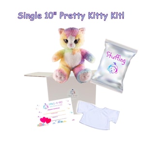 May include: A 10 inch rainbow colored plush kitty in a box with stuffing, a white t-shirt, and an adoption certificate. The box has the words "Make-A-Pet" printed on it. The stuffing bag has the word "Stuffing" printed on it.