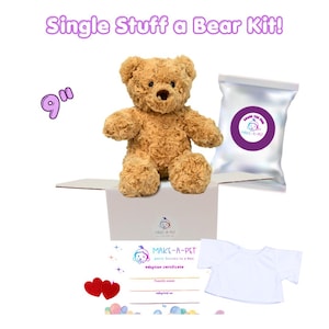 May include: A 9-inch tan teddy bear, a white box, a silver bag with a purple Make-A-Pet logo, a white t-shirt, two red felt hearts, and an adoption certificate with the text Single Stuff a Bear Kit! and Make-A-Pet party fuzzies in a box.
