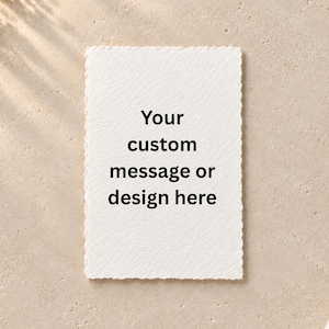 May include: A rectangular white card with a deckled edge featuring the black printed text: Your custom message or design here. The card has a textured paper surface and is positioned vertically against a neutral, light-colored background.
