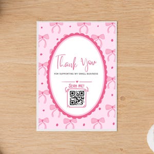 May include: A rectangular thank you card featuring a light pink background with a repeating pattern of small pink bows and dots. A central white oval with a scalloped pink border contains the text Thank You, FOR SUPPORTING MY SMALL BUSINESS, and SCAN ME! above a black and white QR code.