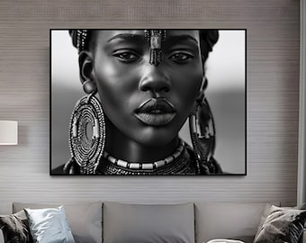 May include: Black and white portrait of a woman wearing traditional African jewelry, including large beaded earrings and a beaded necklace.