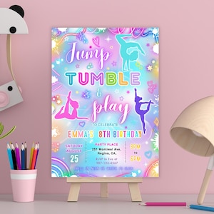 May include: A colorful gymnastics-themed birthday party invitation. The design features the words "Jump, Tumble & Play" with gymnast silhouettes and event details. The invitation is displayed on a small wooden easel.