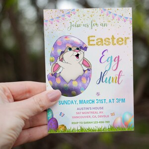 May include: A pastel pink and purple invitation card with a cartoon bunny rabbit peeking out of a cracked egg. The text on the card reads "Join us for an Easter Egg Hunt" and includes the date, time, and location of the event. RSVP information is also included.