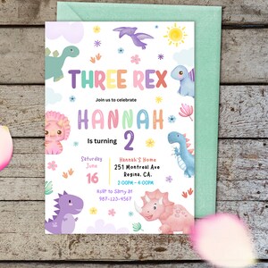 May include: A colorful invitation for a dinosaur themed birthday party for a girl turning two. The invitation features a rainbow colored text that says "Three Rex" and "Hannah is turning 2". The invitation also includes a date and time for the party, as well as the address and RSVP information.