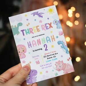 May include: A colorful invitation for a dinosaur themed birthday party for a child named Hannah turning two. The invitation features a rainbow colored text that says "Three Rex" and "Hannah 2" with a variety of dinosaur illustrations. The invitation includes the date, time, and location of the party.