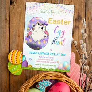 May include: An invitation to an Easter egg hunt with a bunny rabbit peeking out of a purple and white egg. The invitation includes the date, time, and location of the event. RSVP information is also included.