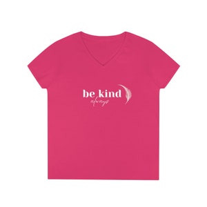 May include: Pink V-neck t-shirt with the text "be kind always" and a white feather graphic.
