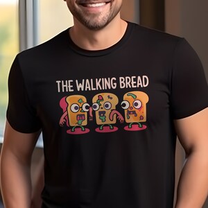 May include: Black t-shirt with a graphic of four cartoon bread slices with faces and the text "THE WALKING BREAD".