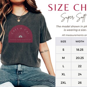 May include: A charcoal grey t-shirt with a maroon arch graphic featuring a sun and the text CALI & CAI. Next to the shirt is a size chart titled SIZE CHART Super Soft Tee, listing sizes S through 2XL with width and length measurements in inches.