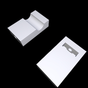 May include: Two white, geometric, rectangular blocks. One block has a curved indentation, and the other has a rectangular cutout with a circular opening. The blocks are set against a black background.