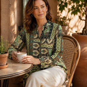 May include: A long-sleeved button-down shirt featuring a multi-coloured green, black, and tan paisley and geometric patchwork pattern, paired with light beige trousers. The shirt has a classic collar and a buttoned front placket design.