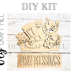 May include: A wooden DIY kit featuring a leprechaun hat with the number 17, a horseshoe, and shamrocks. The kit includes a separate sign that reads "IRISH BLESSINGS". The words "DIY KIT" are at the top.