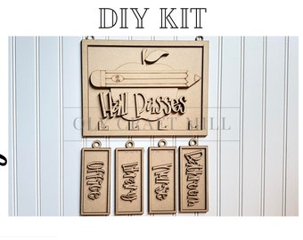 May include: DIY craft kit for a school hall pass sign. The sign features a red apple with a pencil and the words "Hall Passes". There are four additional signs that say "Office", "Library", "Nurse", and "Bathroom".