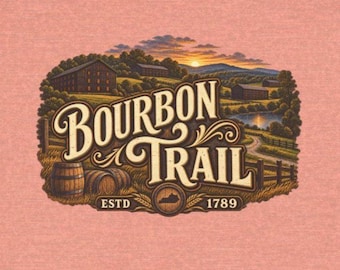 May include: A heathered peach-colored t-shirt featuring a graphic on the back. The design depicts a landscape with buildings, barrels, and a sunset, with the text BOURBON TRAIL and ESTD 1789 printed in a decorative font over a map outline.