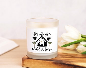 May include: White frosted glass candle with a black and white design featuring a nativity scene with the text "for unto us a child is born".