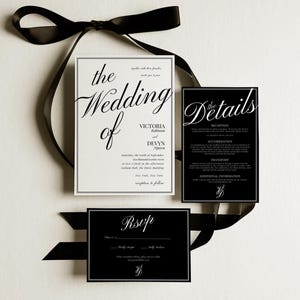 May include: A sophisticated wedding invitation suite with a black ribbon and three cards. The main card reads "The Wedding of Victoria Robinson & Devyn Ngorow." Additional cards include "The Details" and "RSVP" in a classic font.