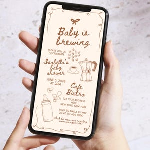 May include: A smartphone displays a baby shower invitation with the text "Baby is brewing." The invitation features illustrations of a coffee pot, coffee beans, a baby bottle, and a pacifier. The event is for Isabella, at Cafe Bistro, June 5, 2026.