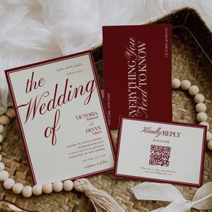 May include: Wedding invitation suite with burgundy text on cream-colored cards. The main invitation reads "the Wedding of Victoria Robinson and Devyn Nguyen." Includes a reply card with a QR code and a card that says "Everything You Need To Know."