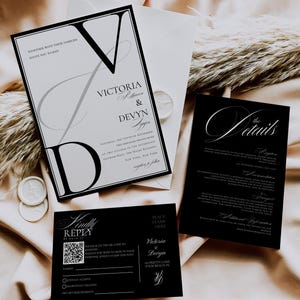 May include: Elegant black and white wedding invitation suite. Includes a main invitation, details card, RSVP card, and envelope. The invitation features the names "Victoria & Devyn" in a stylish font. The suite is set against a soft, neutral background.