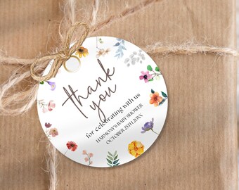 May include: Round thank you tag with a floral design in shades of pink, orange, yellow, and blue. The text reads "Thank you for celebrating with us Harmony's Baby Shower October 25th 20XX".