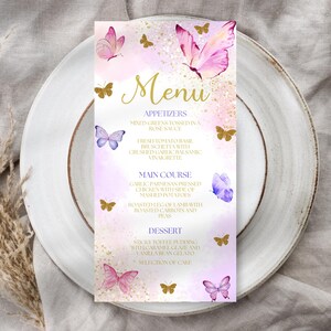 May include: A menu card with a watercolor design featuring pink and purple butterflies and gold accents. The word "Menu" is in gold script. The menu lists appetizers, main courses, and desserts.
