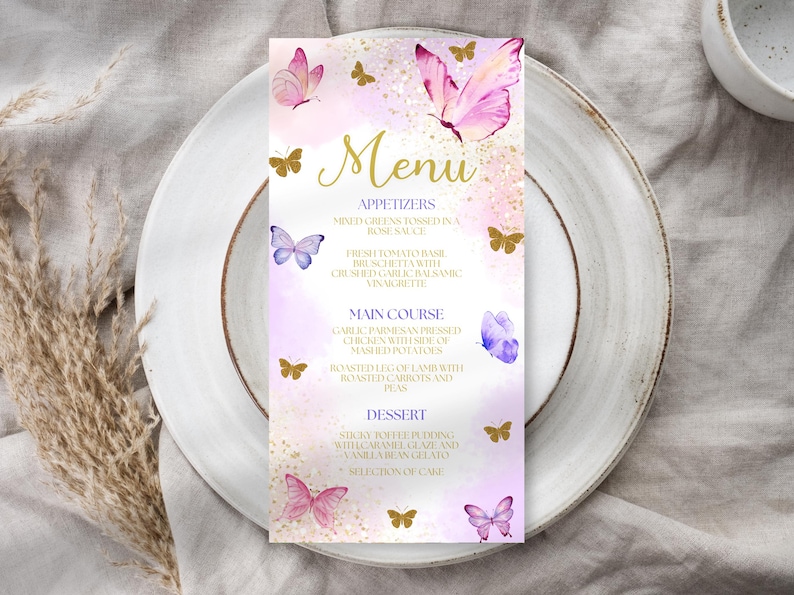 May include: A menu card with a watercolor design featuring pink and purple butterflies and gold accents. The word "Menu" is in gold script. The menu lists appetizers, main courses, and desserts.