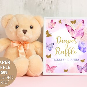 May include: A printable 8x10 inch sign for a diaper raffle. The sign features a purple and pink watercolor background with gold glitter accents and butterflies. The text on the sign reads "Diaper Raffle Tickets + Diapers".