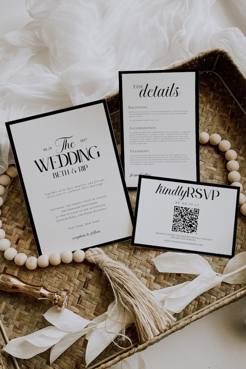 May include: Elegant wedding invitation suite with black text on white cards. The main invitation reads "The Wedding" with the date and names. Includes details and RSVP cards, all with a minimalist design.