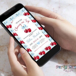 May include: A digital invitation for a baby shower with a cherry and blue ribbon design. The text reads "He is the Cherry on Top" and "Please join us for a baby shower honoring Bella Hadid, Sat July 15, 2PM".