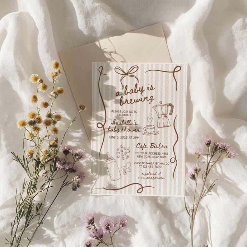 May include: A baby shower invitation with the text "a baby is brewing" and illustrations of a coffee pot, baby bottle, and coffee cup. The invitation is on a striped background with floral accents.