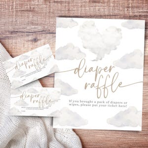 May include: A set of baby shower raffle cards and sign with a cloud theme. The sign and cards have the words "diaper raffle" in a cursive font. The sign reads "If you brought a pack of diapers or wipes, please put your ticket here!"