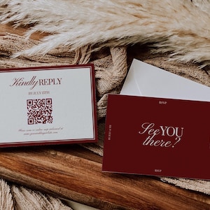 May include: Burgundy and white wedding invitation suite. The invitation card reads "Kindly Reply" with a QR code and date. The RSVP card says "See you there?" with a white envelope on a wooden surface.