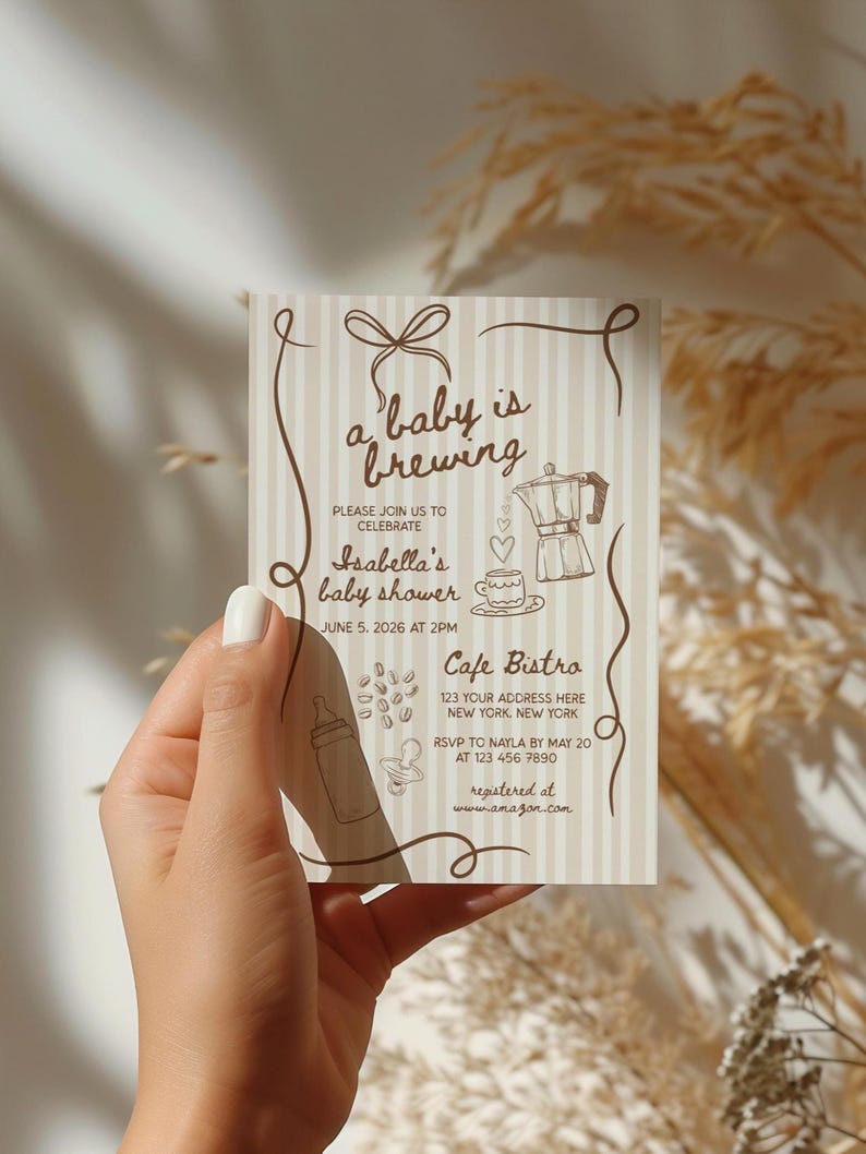 May include: A baby shower invitation card with a beige and white striped background. The card features brown decorative elements, including a bow, swirls, and illustrations of a coffee pot, coffee beans, and a baby bottle. Text on the card reads "a baby is brewing".