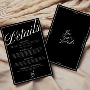 May include: Two black wedding detail cards with white text. One card reads "the Details" in elegant script, listing reception, accommodation, and transport information. The other card says "The Finer Details".