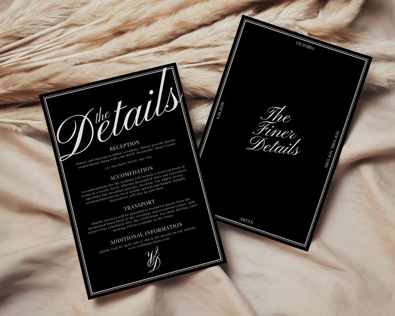 May include: Two black wedding detail cards with white text. One card reads "the Details" in elegant script, listing reception, accommodation, and transport information. The other card says "The Finer Details".