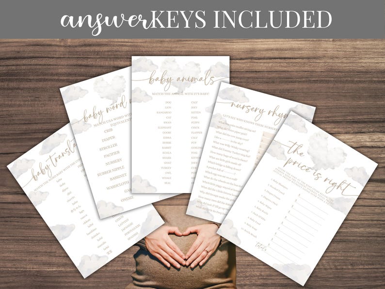 May include: A collection of baby shower game cards with cloud and gold accents, including "Baby Word," "Baby Animals," and "Nursery Rhymes." The text "ANSWER KEYS INCLUDED" is at the top. The cards are arranged on a wooden surface.