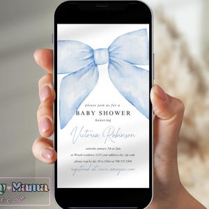 May include: A blue watercolour bow on a white background with text that reads "Please join us for a Baby Shower honouring Victoria Robinson Saturday January 15th at 2pm at Woods residence 1123 your address city, zip code please RSVP by Dec 10 to Ches at 708 325.2304 registered at www.amazon.com"
