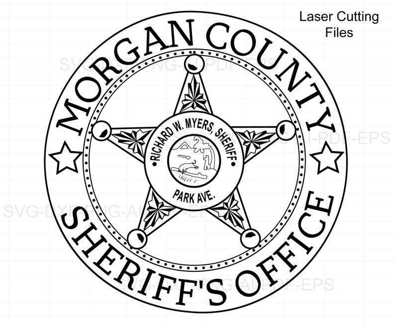 May include: Black and white illustration of a sheriff's badge with the words "Morgan County Sheriff's Office" around the perimeter. The badge features a five-pointed star with a smaller circle in the center that reads "Richard W. Myers, Sheriff, Park Ave."