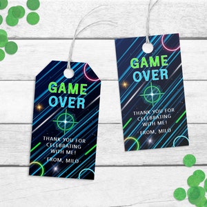 Op de afbeelding: Twee blauwe en zwarte bedankkaartjes met neon groene en roze accenten. De kaartjes hebben de tekst "GAME OVER" en zeggen "Bedankt voor het vieren met me! Van Milo".