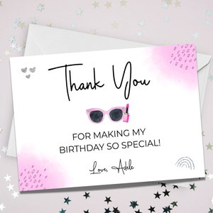 May include: A pink and white thank you card with the text "Thank You" in black script. The card has a pink watercolor background with a pair of pink sunglasses and a pink lipstick. The text "For making my birthday so special!" is printed in black below the sunglasses and lipstick. The card is signed "Love, Adele" in black script.