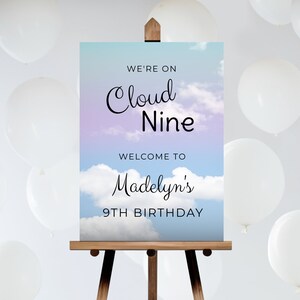 May include: A blue and purple gradient sign with white clouds and the text "We're on Cloud Nine" and "Welcome to Madelyn's 9th Birthday".