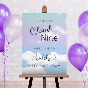 May include: A blue and purple sign with clouds and the text "We're on Cloud Nine" and "Welcome to Madelyn's 9th Birthday".
